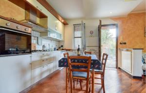 a kitchen with a table and chairs in a room at Awesome Apartment In Casarza Ligure in Casarza Ligure
