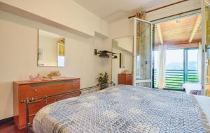 a bedroom with a bed and a dresser and a window at Awesome Apartment In Casarza Ligure in Casarza Ligure