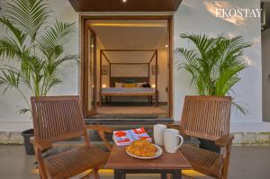 a table with a plate of food on top of two chairs at EKOSTAY - Serenity Villa in Alibaug +24 photos