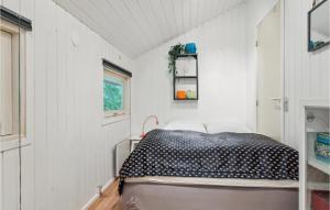 a bedroom with a bed in a white room at 2 Bedroom Beautiful Home In Herning in Kølkær