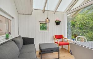 a living room with a couch and a chair at 2 Bedroom Beautiful Home In Herning in Kølkær +6 photos
