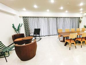 a conference room with a table and chairs at ゲストハウス星風 in Suo Oshima