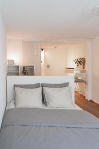 Un dormitorio con una cama grande con almohadas blancas. en MIA Appartements, en Innsbruck