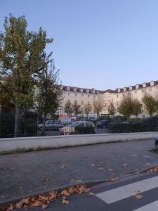 an empty street in front of a large building at Très joli appartement Disneyland Paris 4 pers in Bussy-Saint-Georges +12 photos