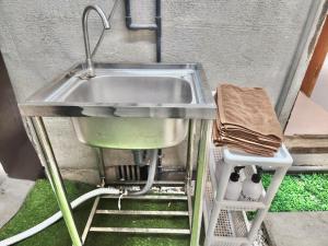 a sink and a shelf under a sink at 9人可能 黒門市場 けんちハウス in Osaka +37 photos