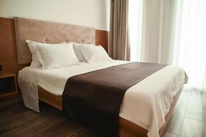 Postel nebo postele na pokoji v ubytování Hotel Albulena
