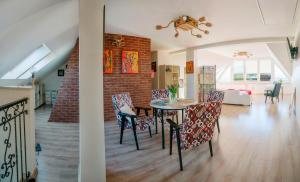 a dining room and living room with a table and chairs at Pokoje Gościnne U Anny in Nowy Targ