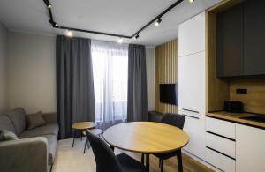 a living room with a table and a couch at Aviva Living by Flat Mаnager in Sofia