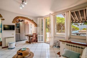 a living room with a large window and a table at Villa Denise in Capoliveri