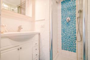 a bathroom with a sink and a shower at Villa Denise in Capoliveri +74 photos