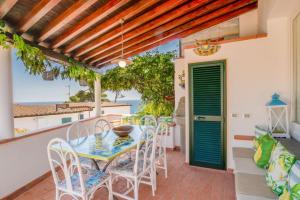 a dining room with a table and chairs on a patio at Villa Denise in Capoliveri
