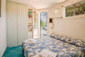 a bedroom with a bed and a window at Villa Denise in Capoliveri