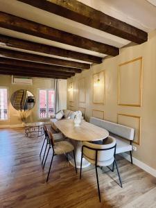 a living room with a table and chairs at Joyau caché en plein cœur de Martigues ! in Martigues