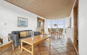 a living room with a couch and a table at 4 Bedroom Stunning Home In Thisted in Thisted