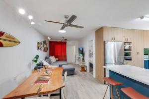 a kitchen and living room with a table and a couch at Beach Baby - Close to Cylinder Beach in Point Lookout +4 photos