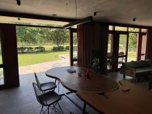 a living room with a wooden table and chairs at BK's Villa Golf View in Nānodra