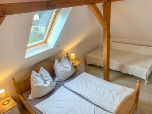 an attic room with two beds and a window at Ferienwohnung Inge in Malchow
