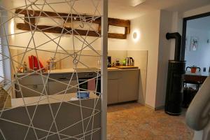 a room with a kitchen with a counter and a room with a kitchenasteryastery at Ferienhaus Blaues Häuschen in Freudenberg am Main