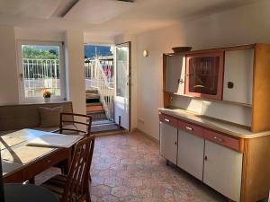 a kitchen with a table and a dining room at Ferienhaus Blaues Häuschen in Freudenberg am Main +33 photos
