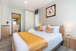 a bedroom with a large bed in a room at The Beach Residence by EHM in Nai Yang Beach +26 photos