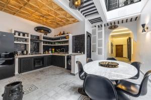 a kitchen with a table and chairs in a room at Riad SASHA Exclusive&New Pool 6 pax Free Breakfast in Marrakech