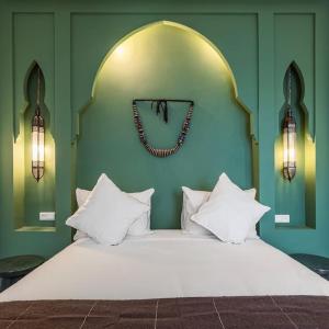 a bedroom with a bed with a clock on the wall at Riad SASHA Exclusive&New Pool 6 pax Free Breakfast in Marrakech