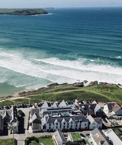 an aerial view of a beach with houses and the ocean at Polzeath Beach House in Polzeath
