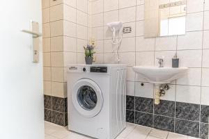 łazienka z pralką i umywalką w obiekcie Spacious 2BR Apt -Near Wiener Stadthalle BurggasseWiener Well Located w Wiedniu