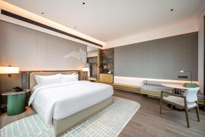 Qinglian Jinghe Hotel Wuhan Zoo International Expo Center Branch客房内的一张或多张床位