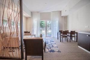 a living room with a table and a dining room at Doral Pool 1407 by WaveProperties in Miami