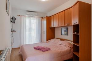 Ένα ή περισσότερα κρεβάτια σε δωμάτιο στο Apartments Kapovic