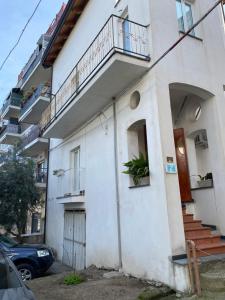 a white building with stairs and a balcony at FF Houses - Centro Storico Ottaviano in Ottaviano +10 photos
