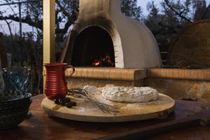 a wooden cutting board with cheese and a fire oven at Happy Villa with Pool - Ideal Villa for Large Groups Near Laganas With a Pool Perfectly Combining Natures Tranquility and Vibrant Entertainment By Villa Mana Gers in Vanáton +40 photos