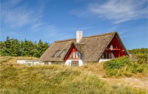 a red and white house on top of a hill at Holiday Home Tingodden Iv in Hvide Sande