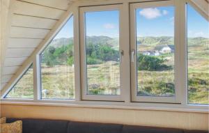 a room with three windows with a couch in front of them at Holiday Home Tingodden Iv in Hvide Sande +18 photos