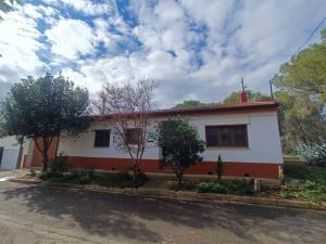 a white and red house with trees in front of it at Casa Rural en Valmuel El Arquero in Valmuel