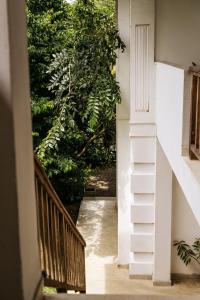 a stairway leading to a room with trees at Watu House in Dickwella