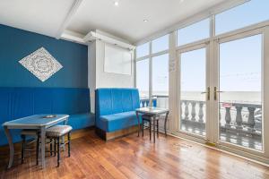 a waiting room with a blue bench and a table at Bluewaters Hotel Blackpool in Blackpool