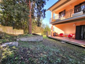 a house with two red chairs on the porch at Locazione Turistica Vista Torricella in Torricella in Sabina +11 photos