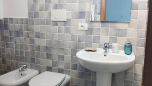 a bathroom with a sink and a toilet at San Giovanni Apartment in Catanzaro