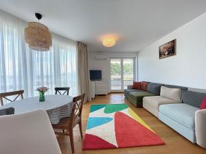 a living room with a couch and a table at Apartment No 207 Lebada Lake Residence in Pantelimon