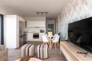 a kitchen and living room with a table and chairs at Perfect View 204 Mossel Cove in Mossel Bay