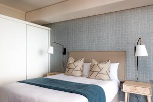 a bedroom with a bed with a blue blanket at Perfect View 204 Mossel Cove in Mossel Bay +14 photos