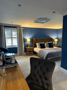 a large bedroom with a bed and a couch at Derby Manor in Bournemouth