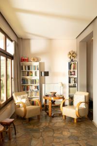 a living room with chairs and a table at Dohos Hotel in Karítsa