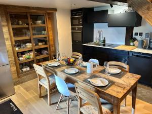 a kitchen with a wooden table and chairs in a kitchen at Chalet traditionnel Haute Nendaz in Nendaz