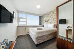a hotel room with a bed and a sink at Bluewaters Hotel Blackpool in Blackpool