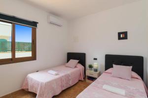 Łóżko lub łóżka w pokoju w obiekcie Villa Maca by Villa Plus