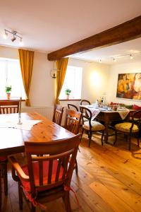 a dining room with wooden tables and chairs at Landhaus - schöne Loh in Weihenzell +25 photos