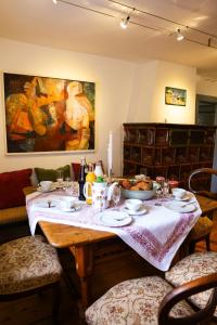 a dining room with a table with food on it at Landhaus - schöne Loh in Weihenzell